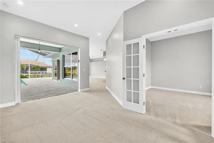 Spare room featuring a sunroom, light carpet, and recessed lighting