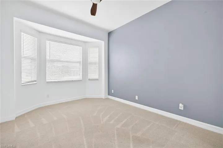 Spare room with light colored carpet and ceiling fan
