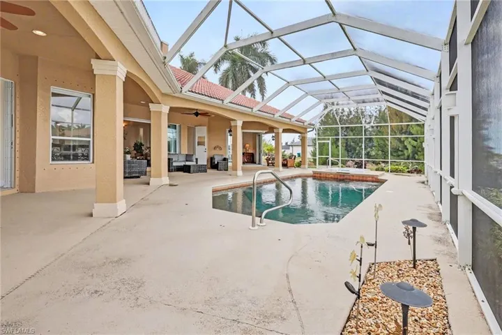 Swimming pool featuring a sunroom, a patio, a lanai, and outdoor lounge area