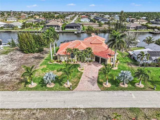 Aerial view of residential area featuring a nearby body of water