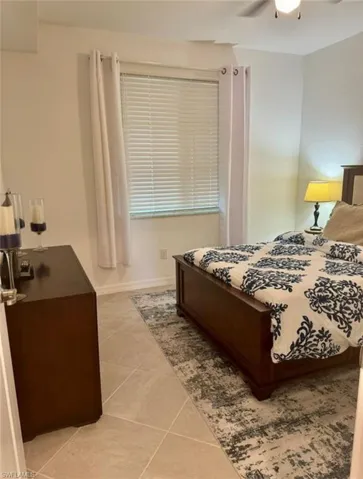 Bedroom featuring a ceiling fan and light tile patterned floors