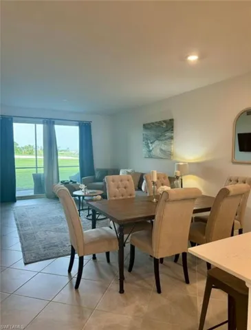 Dining space with recessed lighting and light tile patterned floors
