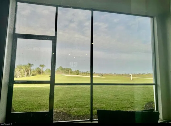 Entryway featuring view of golf course and plenty of natural light