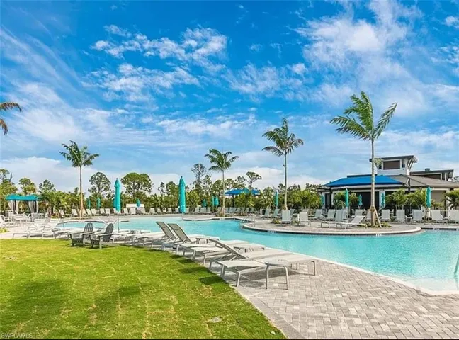 Community pool with a yard and a patio area