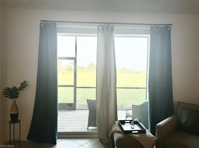 Doorway to outside with tile patterned flooring