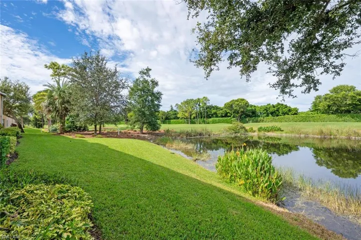 View of green lawn featuring a water view