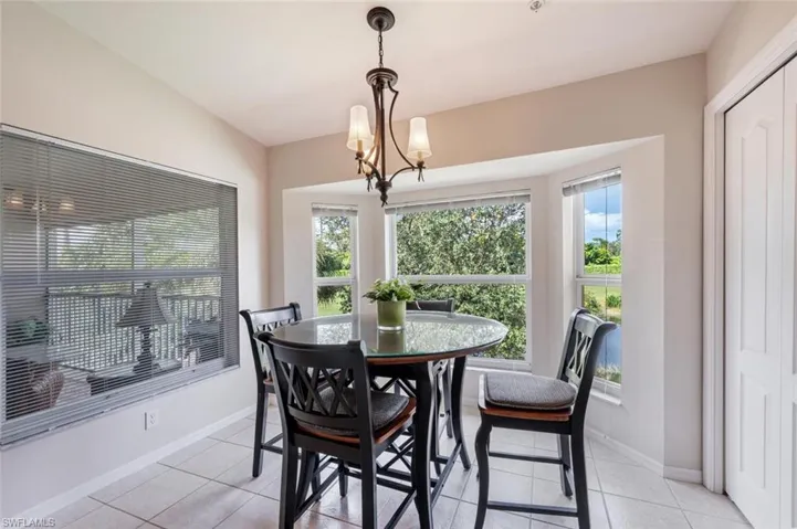 Dining room featuring light tile patterned flooring and a chandelier