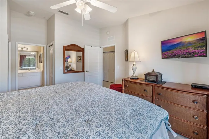 Bedroom with a closet, ceiling fan, and ensuite bathroom