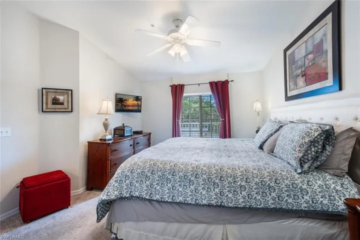 Bedroom featuring carpet flooring, a ceiling fan, and vaulted ceiling