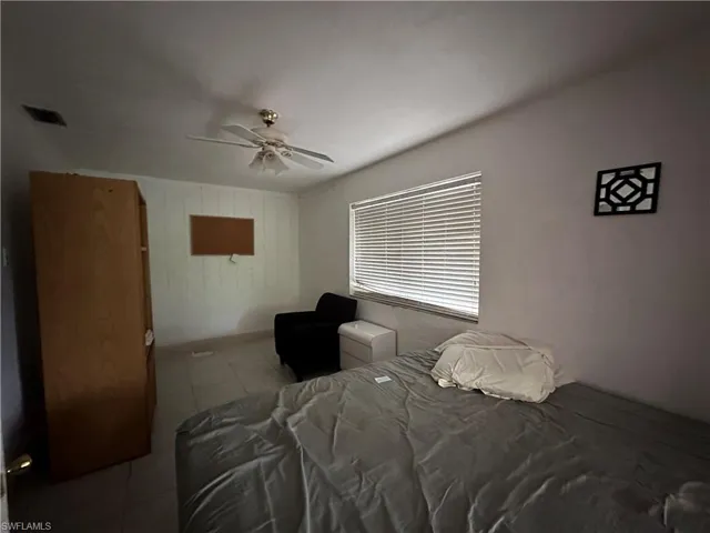 Bedroom featuring tile patterned floors and ceiling fan
