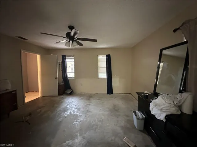 Bedroom with a textured ceiling and ceiling fan