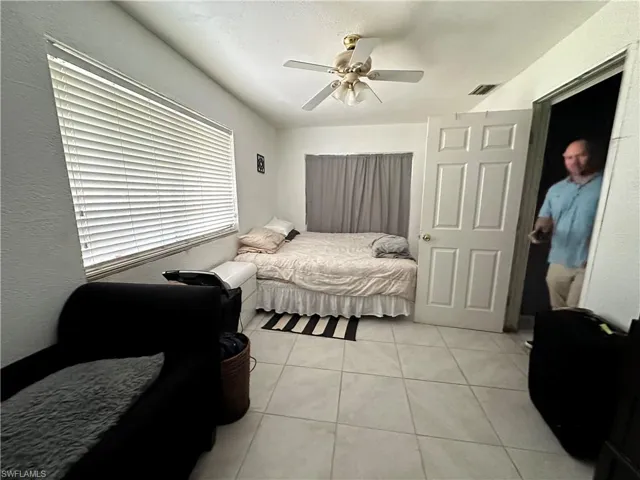 Tiled bedroom with ceiling fan