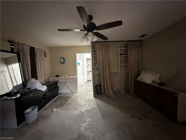 Bedroom featuring concrete floors and ceiling fan