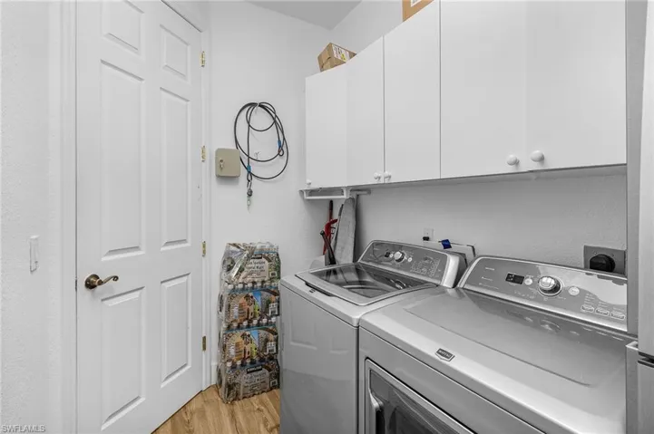 laundry room including full size refrigerator