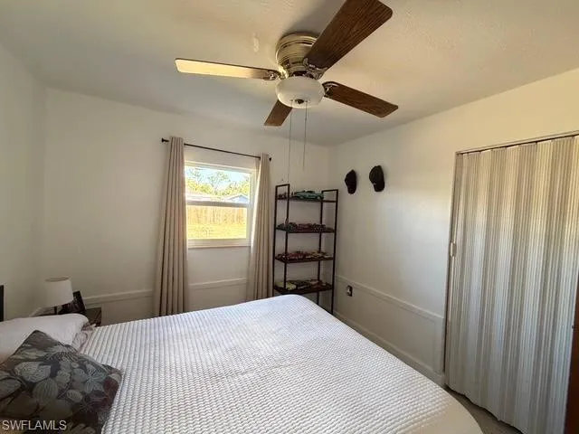 Bedroom with a ceiling fan and a closet