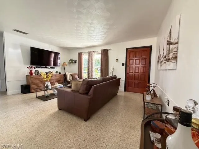 Living room featuring dark aggregate flooring