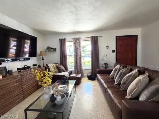Living room with dark aggregate flooring