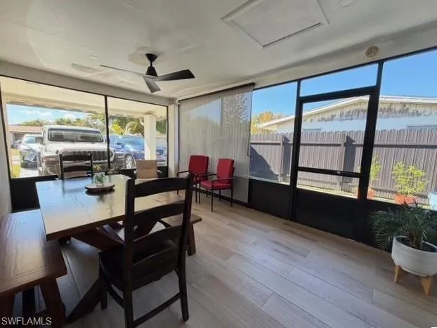 Sunroom featuring wood finished floors and healthy amount of natural light
