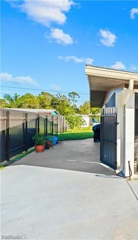 View of parking / parking lot featuring a fenced backyard