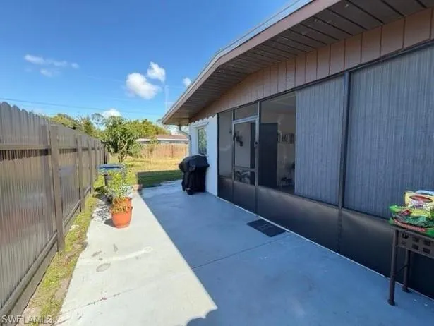 Fenced backyard with area for grilling and a patio area
