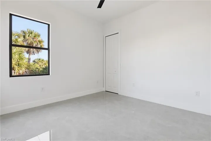 Empty room featuring baseboards and ceiling fan