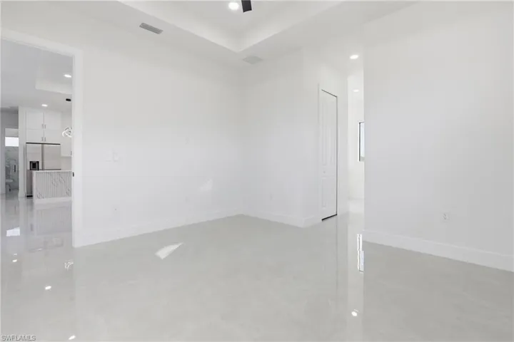 Spare room with recessed lighting and a tray ceiling