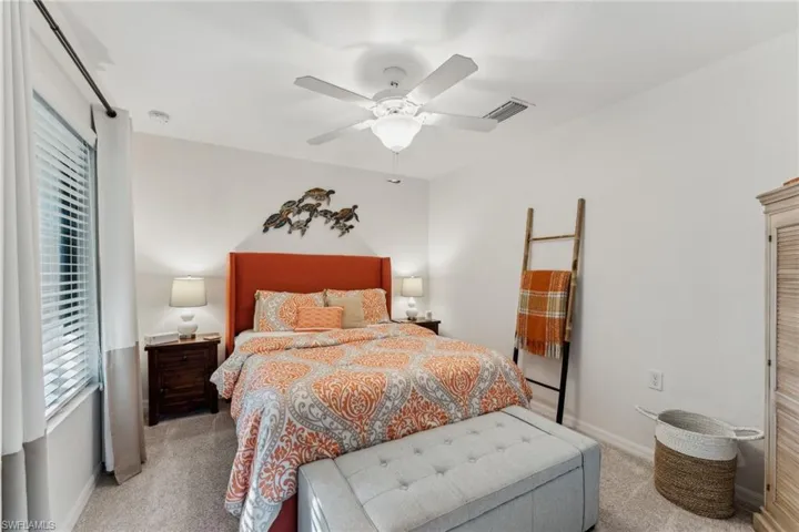 Carpeted bedroom with ceiling fan