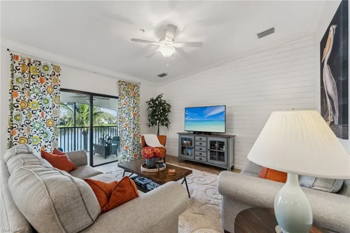 Living room featuring crown molding and ceiling fan