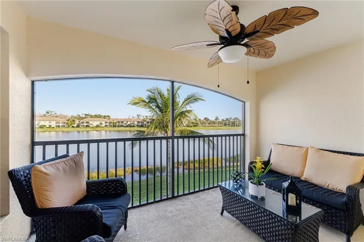 Sunroom featuring a water view and ceiling fan