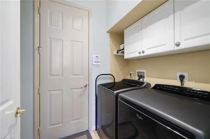 Laundry room featuring cabinet space