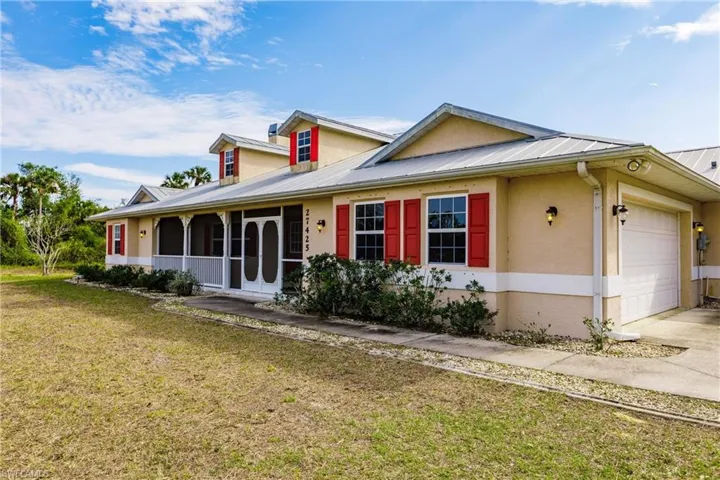 View of front of house with a garage and a front lawn