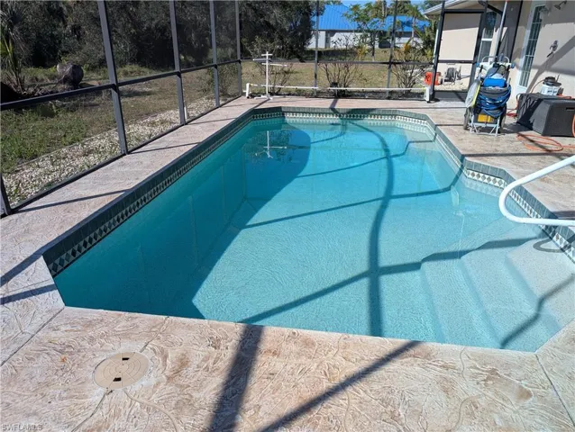 View of pool with a lanai