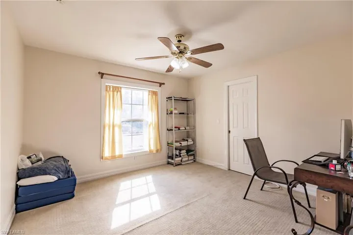 Carpeted office with ceiling fan