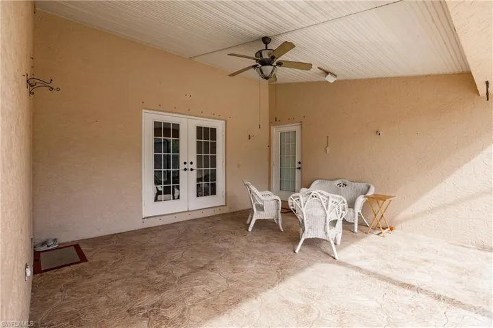 View of patio with ceiling fan and french doors