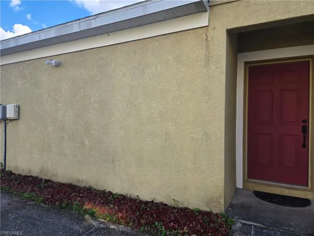 View of exterior entry featuring stucco siding