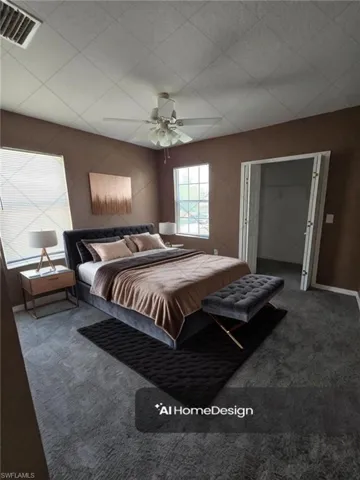 Carpeted bedroom featuring visible vents and ceiling fan