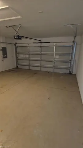 Garage with a garage door opener and electric panel