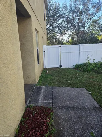 View of yard featuring a patio area, a gate, and fence