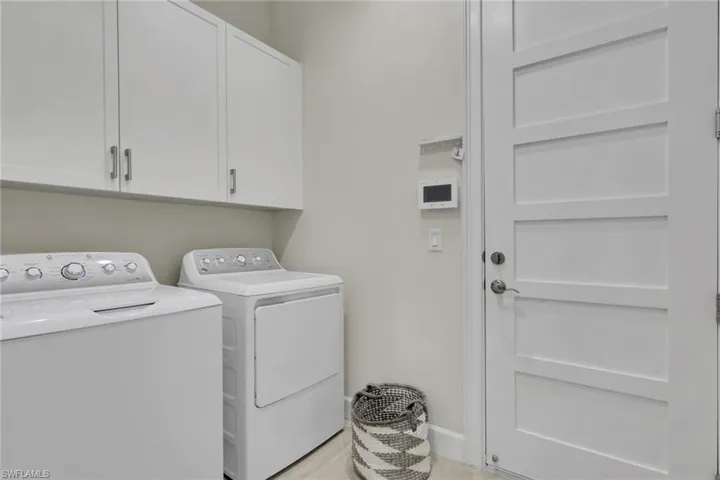 Laundry area with washing machine and clothes dryer and cabinet space