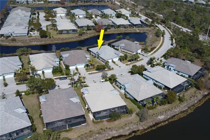 Aerial view of property's location featuring nearby suburban area and a large body of water