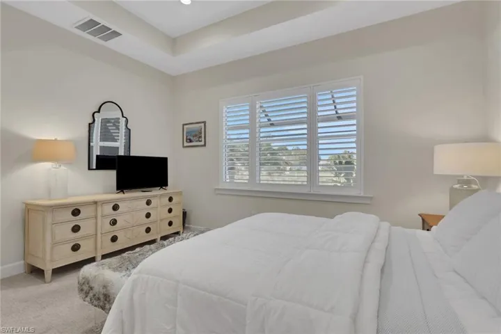 Carpeted bedroom featuring baseboards