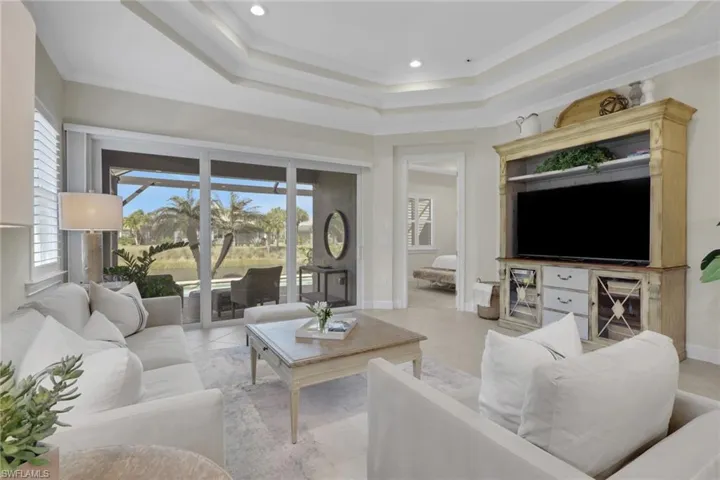 Living room with light tile patterned floors and recessed lighting