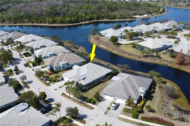 Aerial view of residential area featuring a large body of water