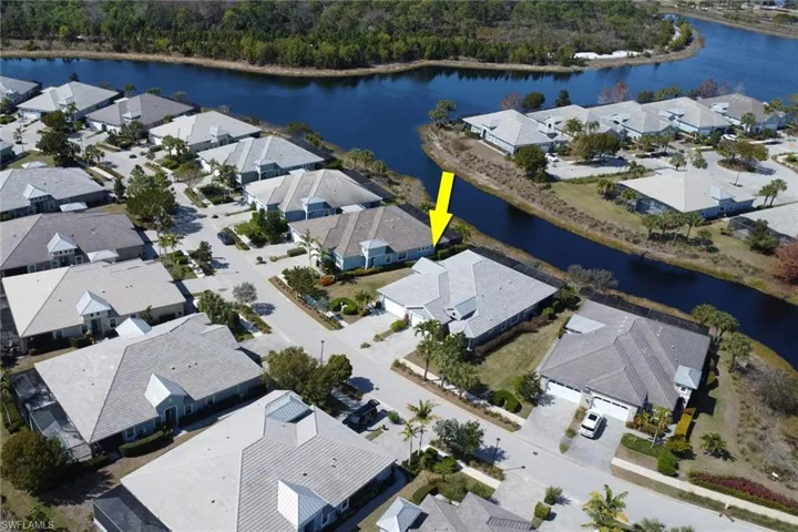 Aerial view of residential area featuring a nearby body of water