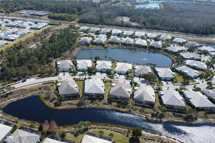 Aerial overview of property's location featuring nearby suburban area and a nearby body of water