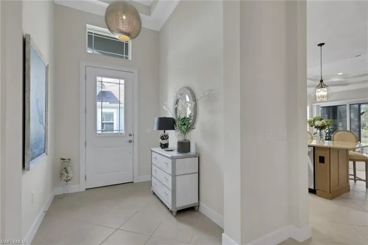 Foyer featuring baseboards and light tile patterned floors
