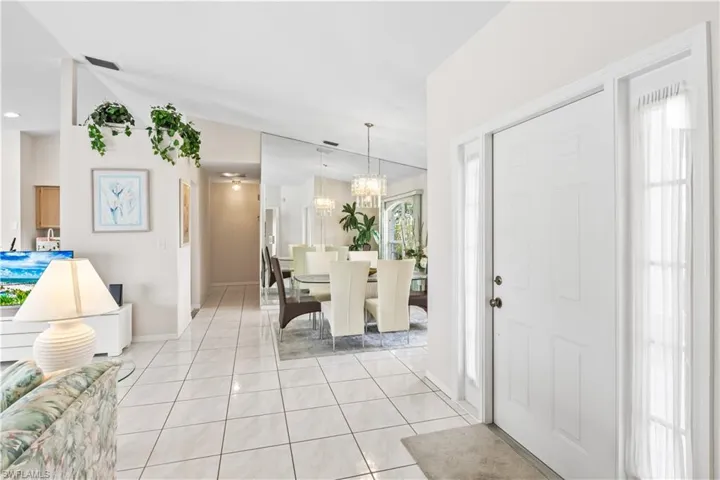 Tiled foyer with a chandelier