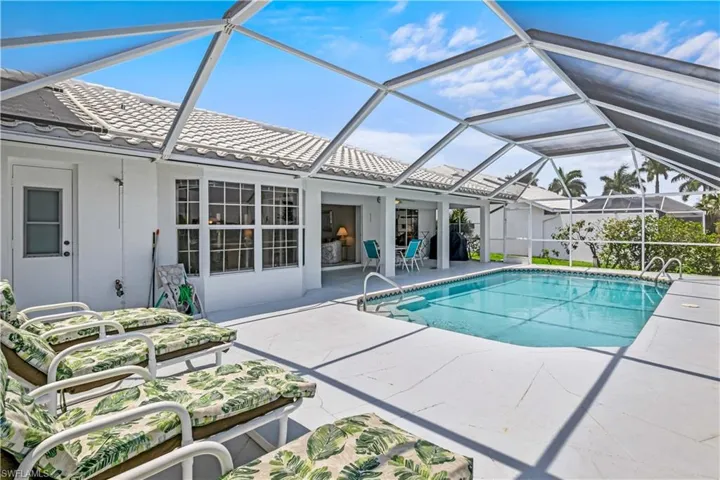 View of pool with a patio and a lanai