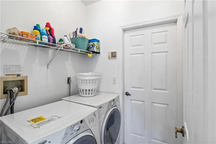 Clothes washing area with electric dryer hookup, washer hookup, and washing machine and clothes dryer