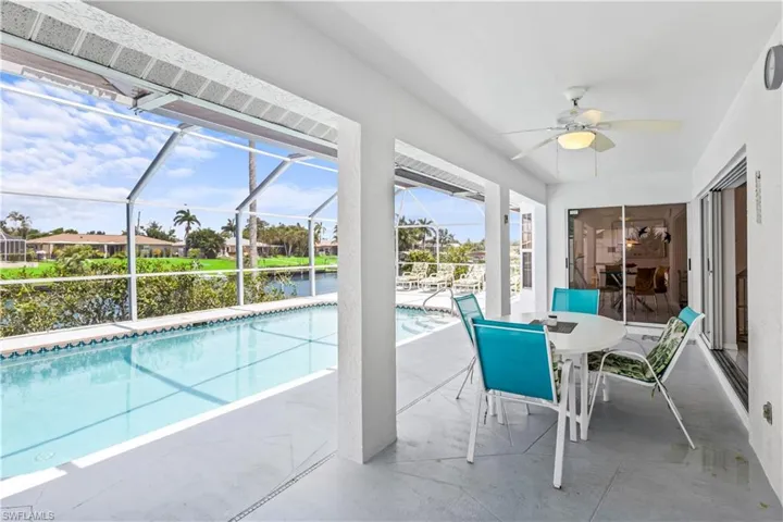 View of pool featuring ceiling fan